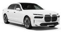 A white BMW sedan is shown from a front corner angle, highlighting its sleek design, large grille, and alloy wheels.