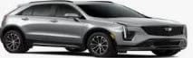 A silver Cadillac SUV parked, viewed from the front passenger side.