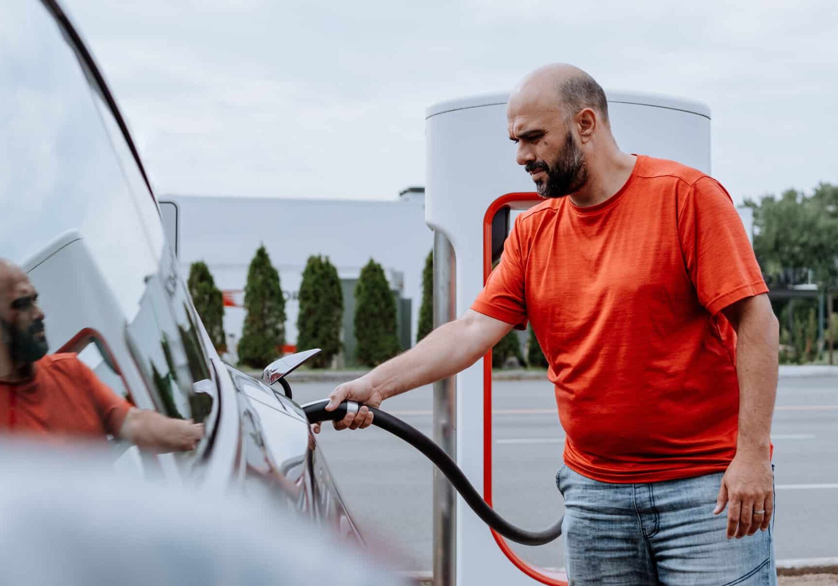 A man is charging his GOEVIN car at a charging station.